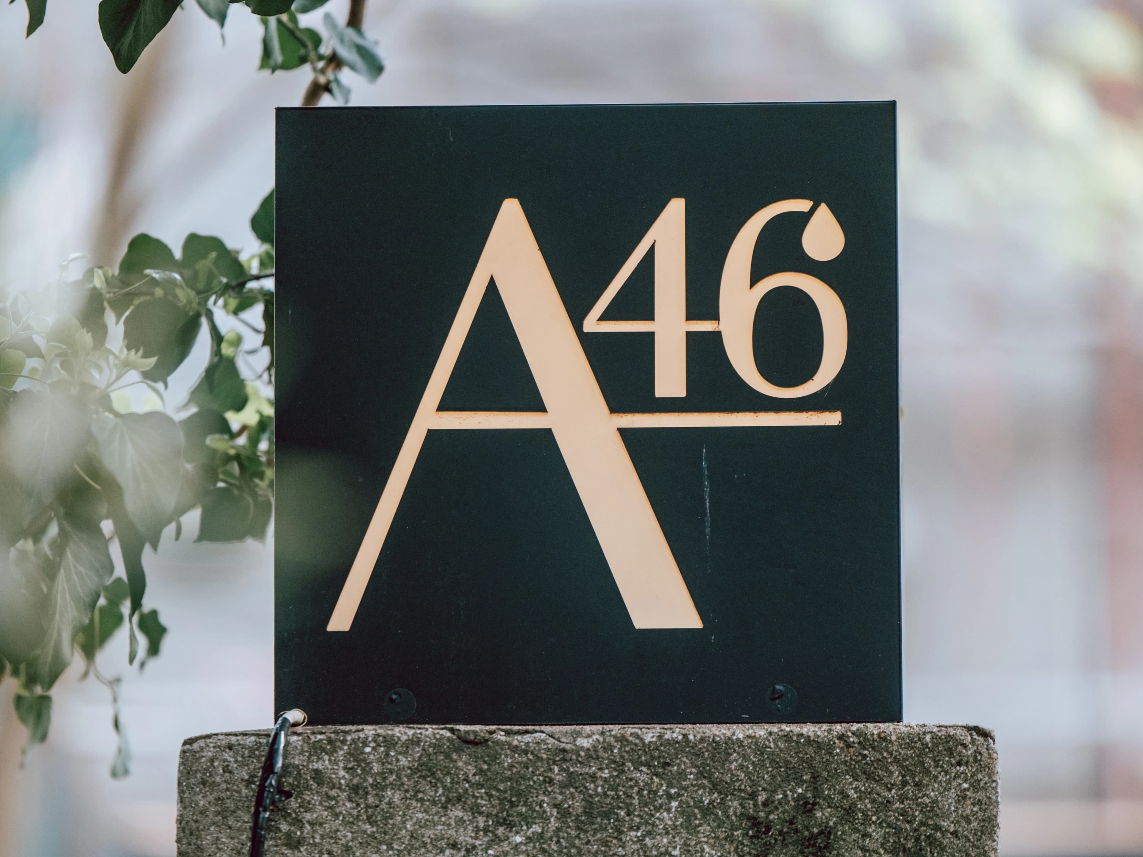 Sigla restaurantului A46 încadrată de verdeața grădinii